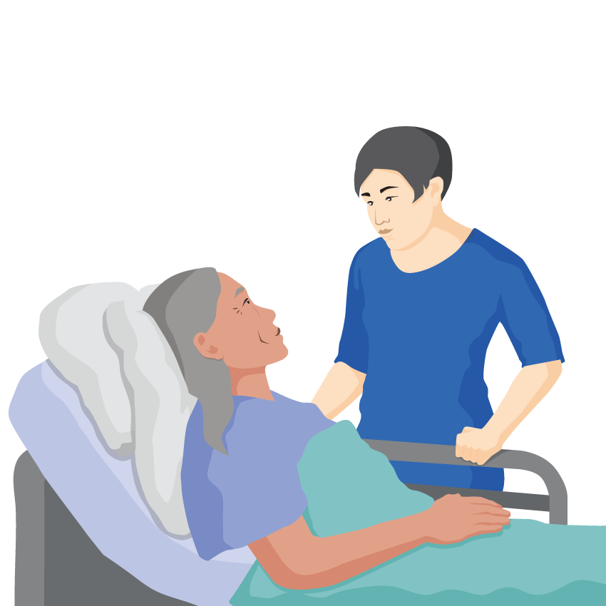 A person is standing next to another person lying in a hospital bed